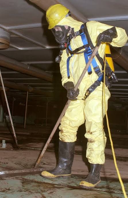 Tank cleaning technician in protective equipment